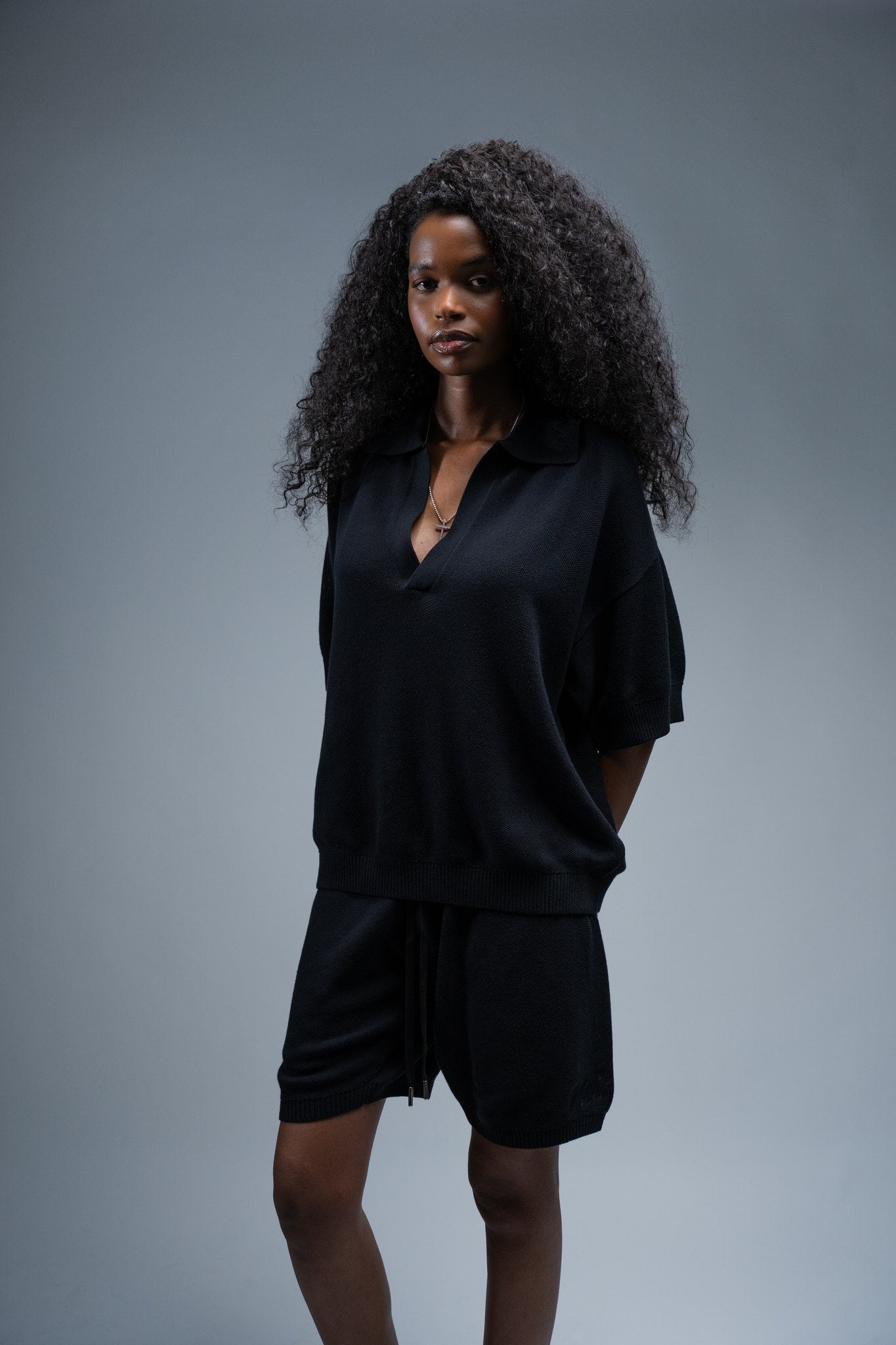 MELI V-NECK KNIT POLO — BLACK — Female model