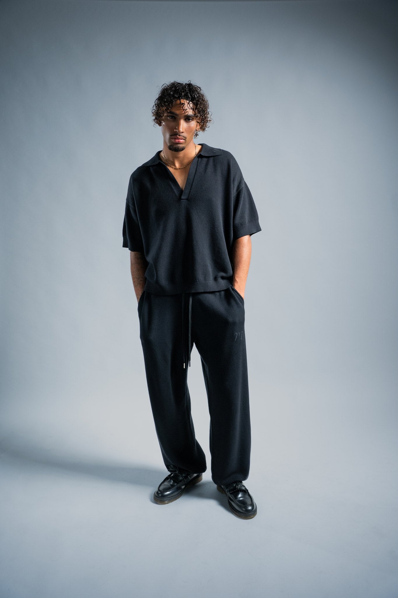 MELI V-NECK KNIT POLO — BLACK — Male model
