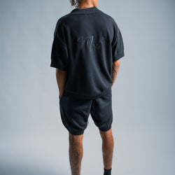MELI V-NECK KNIT POLO — BLACK — Male model