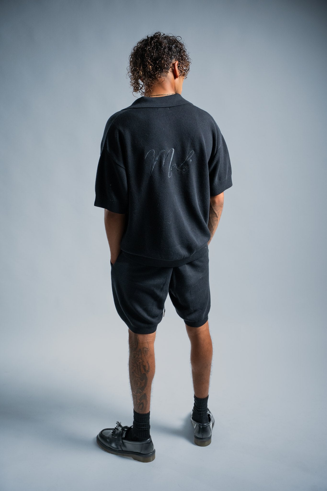 MELI V-NECK KNIT POLO — BLACK — Male model