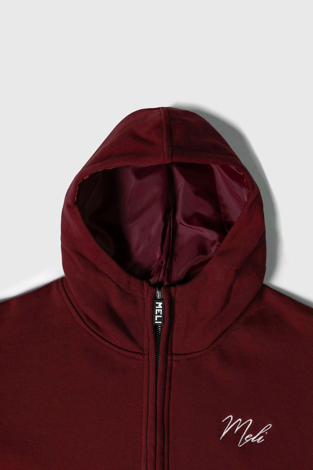MELI Global Sweatsuit 3.0 in Crimson, structured satin lined hood