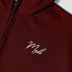 MELI Global Sweatsuit 3.0 in Crimson, hidden half zip and embroidered MELI script at the chest