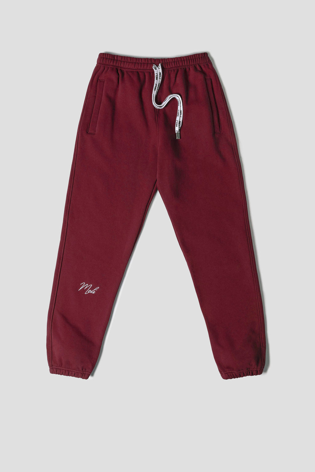 MELI Global Sweatsuit 3.0 in Crimson, sweatpant front with MELI drawstrings and MELI script at the leg