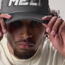The MELI Motorsports trucker hat, worn