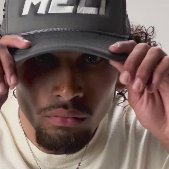 The MELI Motorsports trucker hat, worn