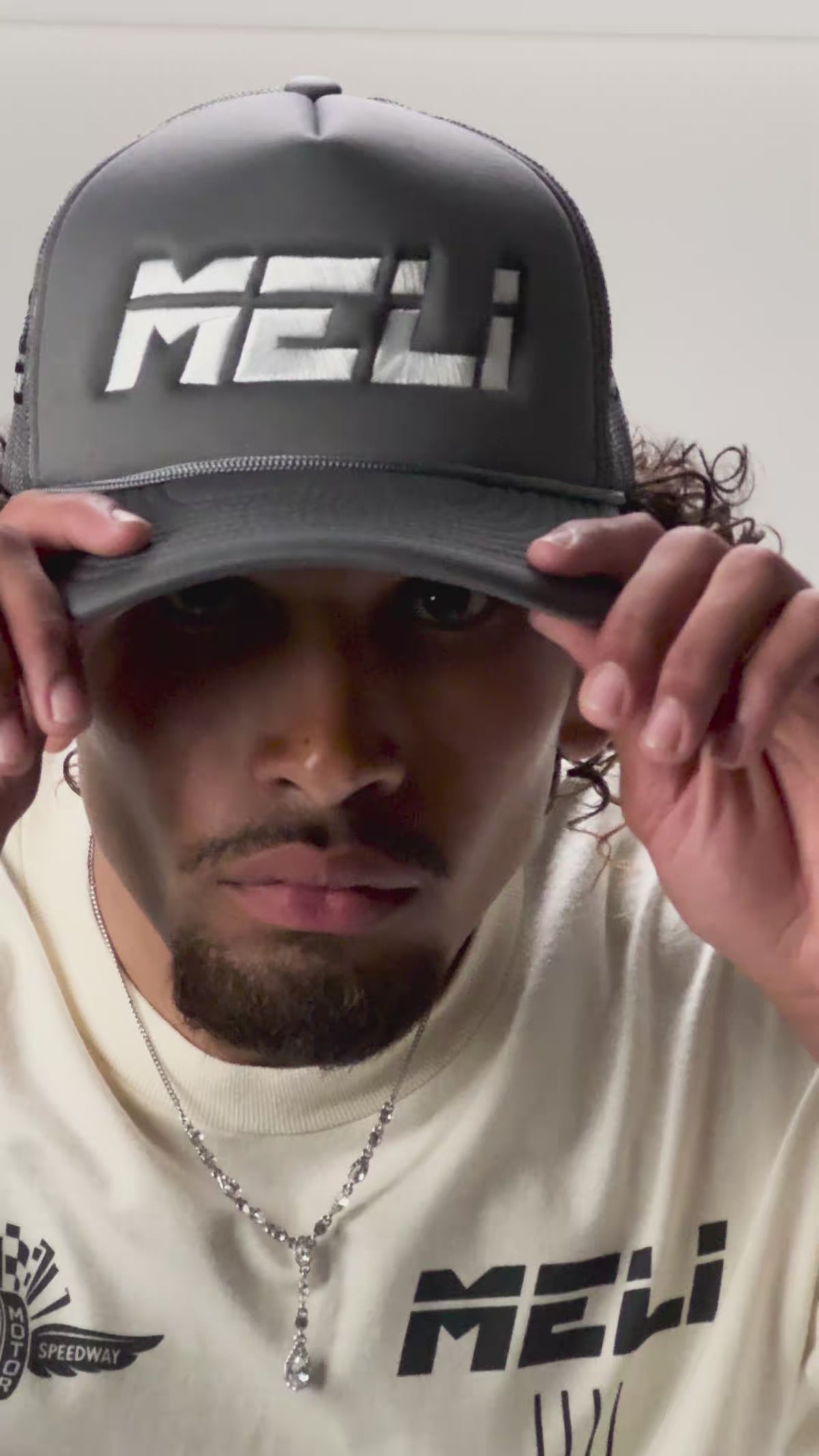 The MELI Motorsports trucker hat, worn